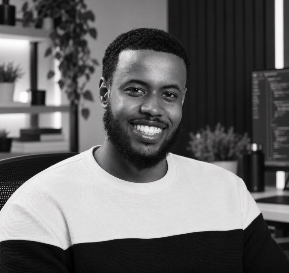 Abdikarim, Coderaxa’s founder and developer, smiling in his workspace